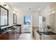 Bright bathroom showcasing double sinks, a glass shower, and access to a private balcony at 1080 Peachtree Ne St # 2309, Atlanta, GA 30309