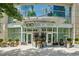 Welcoming building entrance with manicured landscaping and prominent signage at 1080 Peachtree Ne St # 2309, Atlanta, GA 30309