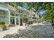 Building entrance with glass doors, modern planters, and sidewalk patio seating at 1080 Peachtree Ne St # 2309, Atlanta, GA 30309