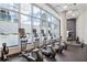 State-of-the-art fitness center with cardio machines and floor-to-ceiling windows at 1080 Peachtree Ne St # 2309, Atlanta, GA 30309