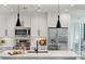 Well-equipped modern kitchen featuring stainless steel appliances, stylish pendant lights and ample storage at 1080 Peachtree Ne St # 2309, Atlanta, GA 30309