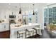 Modern kitchen featuring stainless steel appliances, quartz countertops, and a large island with seating at 1080 Peachtree Ne St # 2309, Atlanta, GA 30309