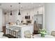 Modern kitchen features white cabinets, stainless steel appliances, a center island with seating, and pendant lighting at 1080 Peachtree Ne St # 2309, Atlanta, GA 30309