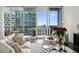 Bright living room featuring comfortable seating and a large window with an amazing city view at 1080 Peachtree Ne St # 2309, Atlanta, GA 30309