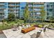 Inviting outdoor lounge area with comfortable seating, a modern fire pit, and lush landscaping at 1080 Peachtree Ne St # 2309, Atlanta, GA 30309