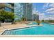 Relaxing outdoor pool with comfortable seating, views of the city, and lush landscaping at 1080 Peachtree Ne St # 2309, Atlanta, GA 30309