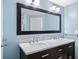 Bathroom with double sink vanity with marble countertop, black cabinets, and a large framed mirror at 1379 Keys Lake Ne Dr, Brookhaven, GA 30319