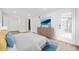 Bright bedroom with hardwood floors, white walls, large bed, and glass door overlooking the outdoor landscape at 1379 Keys Lake Ne Dr, Brookhaven, GA 30319