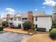 Well-maintained condo with neutral siding, brick chimney, second-floor balcony, and wooden access bridge at 1379 Keys Lake Ne Dr, Brookhaven, GA 30319