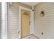 Close-up of the front door with a half-moon window, set against light siding and a lamp at 1379 Keys Lake Ne Dr, Brookhaven, GA 30319