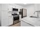 The kitchen features white cabinets, stainless steel appliances, and marble countertops at 1379 Keys Lake Ne Dr, Brookhaven, GA 30319