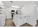 Bright kitchen features white cabinets, stainless steel appliances, and a marble countertop island with seating at 1379 Keys Lake Ne Dr, Brookhaven, GA 30319