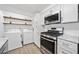 This bright laundry area offers modern appliances, ample counter space, and sleek white cabinetry at 1379 Keys Lake Ne Dr, Brookhaven, GA 30319