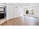 Bright living room with hardwood floors, white walls, and large windows overlooking the outdoor landscape at 1379 Keys Lake Ne Dr, Brookhaven, GA 30319
