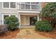 View of the patio with a sliding glass door and stone walkway surrounded by shrubbery at 1379 Keys Lake Ne Dr, Brookhaven, GA 30319
