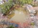 Aerial view of a community pond surrounded by trees at 1379 Keys Lake Ne Dr, Brookhaven, GA 30319