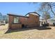 View of the backyard featuring a brick house with large windows and grass lawn at 2128 Jones Nw Rd, Atlanta, GA 30318