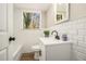 Updated bathroom with white subway tiles, modern vanity, and window at 2128 Jones Nw Rd, Atlanta, GA 30318