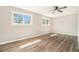 A bedroom with wood-look floors, ceiling fan, and plenty of natural light at 2128 Jones Nw Rd, Atlanta, GA 30318