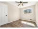 A bedroom with wood-look floors, a ceiling fan, and a bright window at 2128 Jones Nw Rd, Atlanta, GA 30318