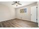 Bedroom features hardwood floors, neutral walls, and large window at 2128 Jones Nw Rd, Atlanta, GA 30318