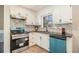 Updated kitchen features white cabinets, gray backsplash, and modern appliances at 2128 Jones Nw Rd, Atlanta, GA 30318