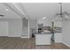 Open kitchen and dining area with modern white cabinetry and wood-look floors at 2128 Jones Nw Rd, Atlanta, GA 30318