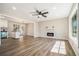 Bright living room features a modern fireplace, ceiling fan and sleek, wood-look flooring at 2128 Jones Nw Rd, Atlanta, GA 30318