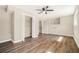 Bright living room with new wood flooring, ceiling fan, closet and access to other rooms at 2128 Jones Nw Rd, Atlanta, GA 30318
