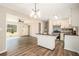Open-concept living and kitchen area with hardwood floors and island with black countertop at 2128 Jones Nw Rd, Atlanta, GA 30318