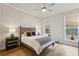 Cozy bedroom features a ceiling fan, natural light from the windows and hardwood floors at 226 Idylwilde Way, Canton, GA 30115