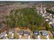 Aerial view of a neighborhood with lush greenery and well-maintained homes in a suburban setting at 3876 Elm Trace Ct, Loganville, GA 30052