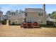 Backyard view of two-story home, showcasing the exterior and deck, set in a grassy landscape at 3876 Elm Trace Ct, Loganville, GA 30052