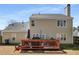 Backyard view of two-story home, showcasing the exterior and deck, set in a grassy landscape at 3876 Elm Trace Ct, Loganville, GA 30052