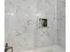 Elegant bathroom boasts marble tiling in shower with built in shelving at 3876 Elm Trace Ct, Loganville, GA 30052