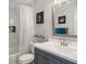 Bathroom featuring a shower-tub combo, sleek vanity, and modern fixtures at 3876 Elm Trace Ct, Loganville, GA 30052