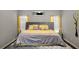 A spacious bedroom featuring gray walls, wood floors, yellow accents, and ample natural light at 3876 Elm Trace Ct, Loganville, GA 30052