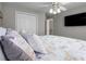 Cozy bedroom with neutral walls and carpet, large closet, ceiling fan, and mounted TV at 3876 Elm Trace Ct, Loganville, GA 30052