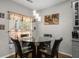 Cozy breakfast nook features a glass-top table, leather chairs, and elegant lighting at 3876 Elm Trace Ct, Loganville, GA 30052