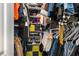 Walk-in closet with custom shelves and hanging racks filled with clothes and accessories at 3876 Elm Trace Ct, Loganville, GA 30052