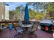Outdoor deck with table, chairs, umbrella, and grill, perfect for backyard entertaining at 3876 Elm Trace Ct, Loganville, GA 30052
