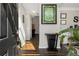 Inviting entryway with dark wood floors, decorative accents, and an abundance of natural light streaming through the front door at 3876 Elm Trace Ct, Loganville, GA 30052