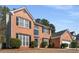 Brick two-story home with an attached two-car garage, surrounded by a well-manicured lawn at 3876 Elm Trace Ct, Loganville, GA 30052