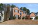 Charming brick two-story home with an attached two-car garage, surrounded by mature trees at 3876 Elm Trace Ct, Loganville, GA 30052