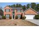 Charming two-story brick home with a well-manicured lawn and a two-car garage at 3876 Elm Trace Ct, Loganville, GA 30052