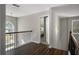 Upstairs landing with hardwood floors and decorative railing leads to the bedrooms at 3876 Elm Trace Ct, Loganville, GA 30052