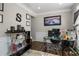 Well-lit home office with a glass desk, stylish decor, and modern furnishings, creating a comfortable workspace at 3876 Elm Trace Ct, Loganville, GA 30052