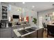 Well-lit kitchen boasts stainless steel appliances, granite countertops, and ample cabinet space at 3876 Elm Trace Ct, Loganville, GA 30052