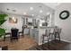 Modern kitchen with stainless steel appliances, granite countertops, and an island with bar seating, perfect for entertaining at 3876 Elm Trace Ct, Loganville, GA 30052