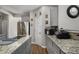 Modern kitchen featuring granite countertops, stainless steel appliances, ample cabinet space, and a convenient layout at 3876 Elm Trace Ct, Loganville, GA 30052